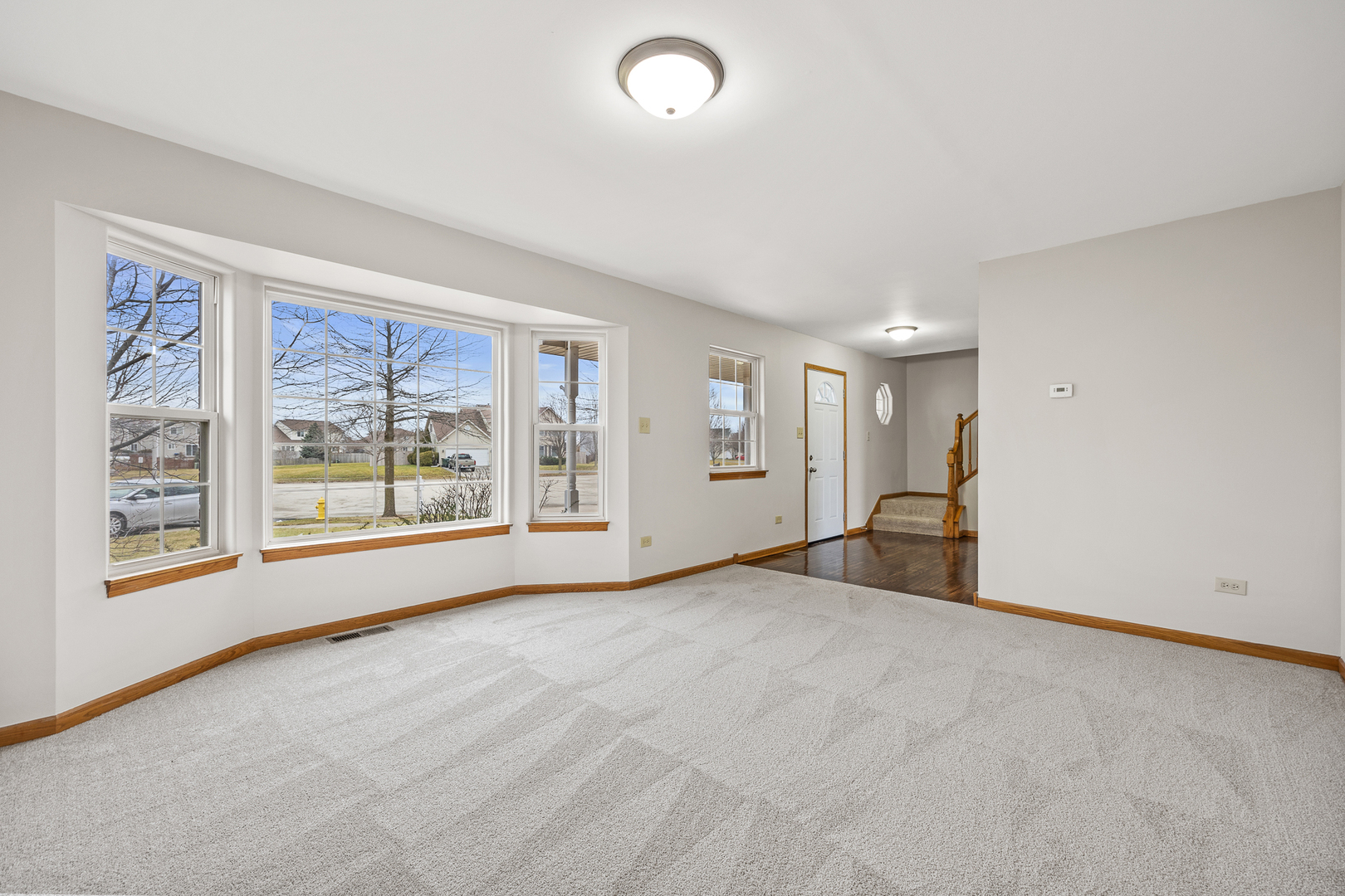 25210 Plainview Drive Channahon, IL 60410 - Photo 4 of 33 a view of an empty room with a window and a kitchen