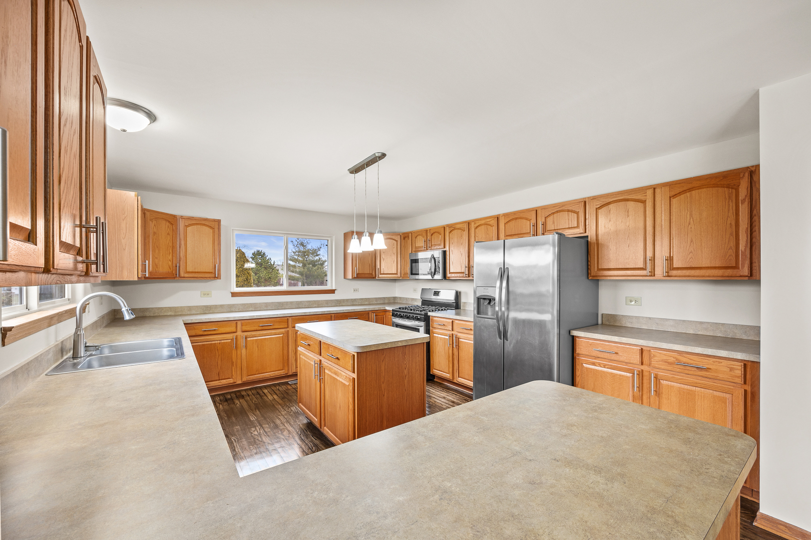 25210 Plainview Drive Channahon, IL 60410 - Photo 9 of 33 a kitchen with stainless steel appliances granite countertop a sink stove and refrigerator