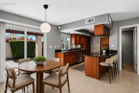 a kitchen with granite countertop a sink stainless steel appliances and cabinets
