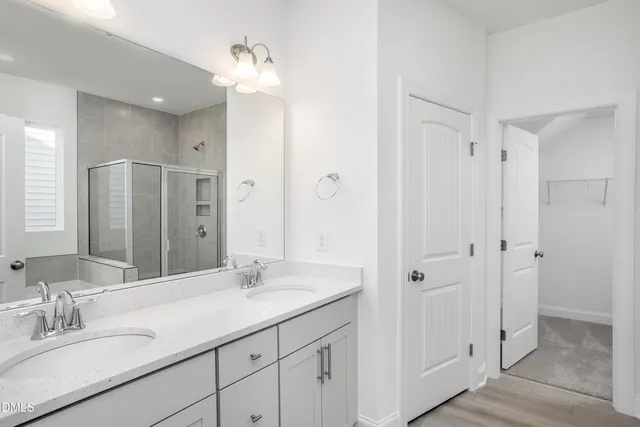 a bathroom with a double vanity sink and mirror