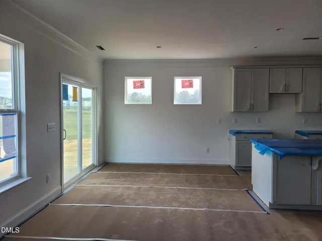 a view of kitchen with granite countertop cabinets next to a window