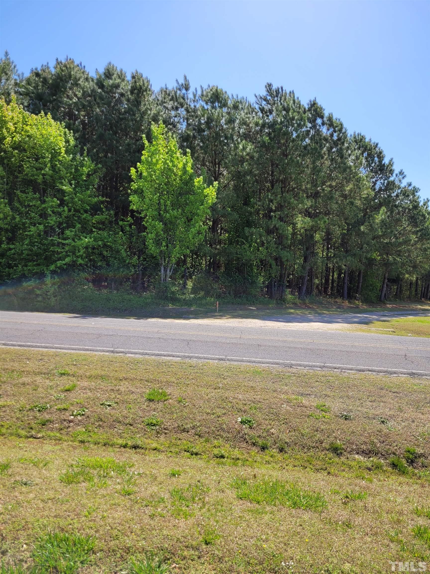0 Water Plant Road East Zebulon, NC 27597 - Photo 8 of 8 a view of a swimming pool with an outdoor space and seating area