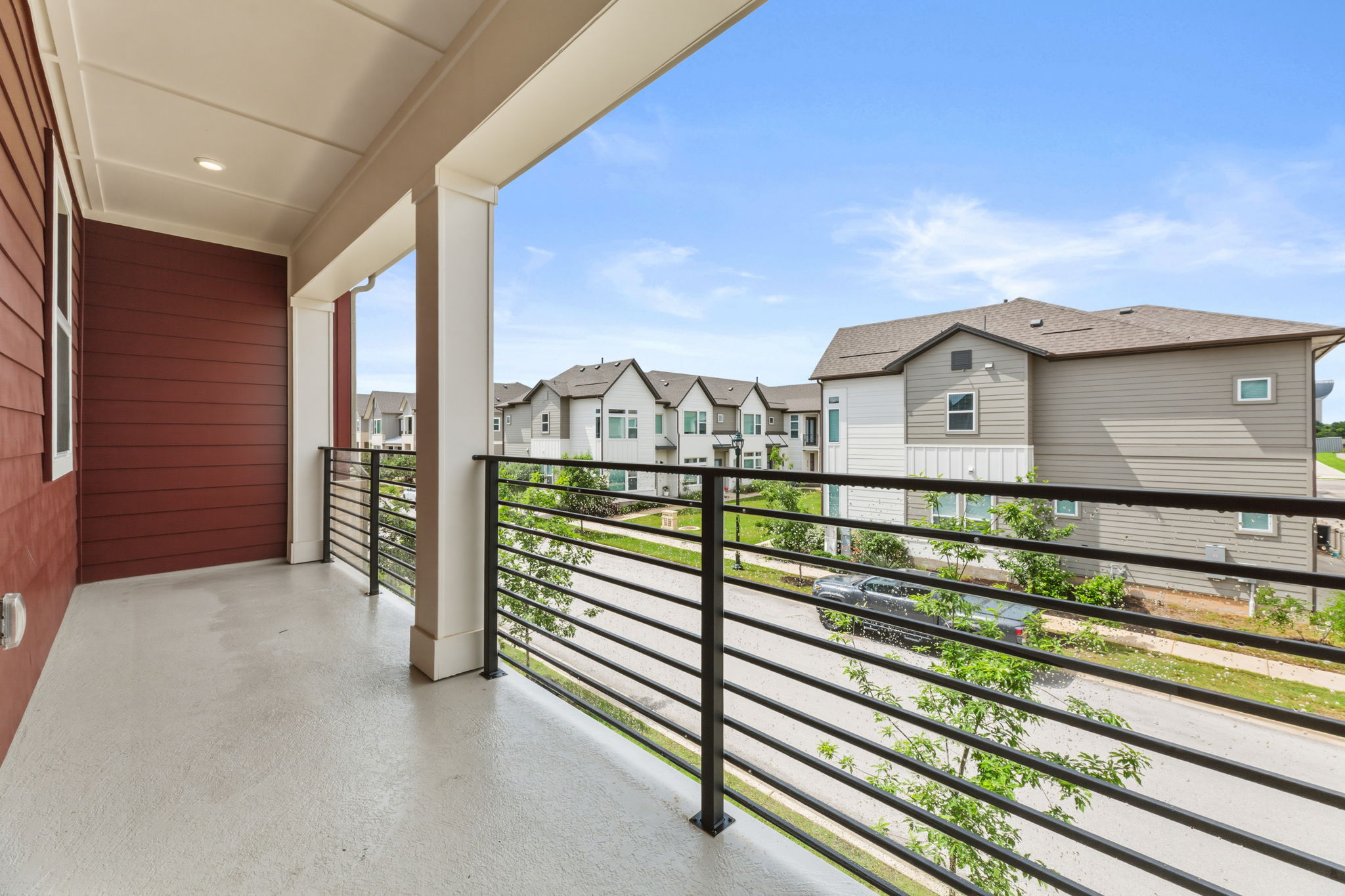 2929 Moreno Street Austin, TX 78723 - Photo 36 of 40 Covered balcony featuring a concrete surface, horizontal metal railings, and substantial support columns