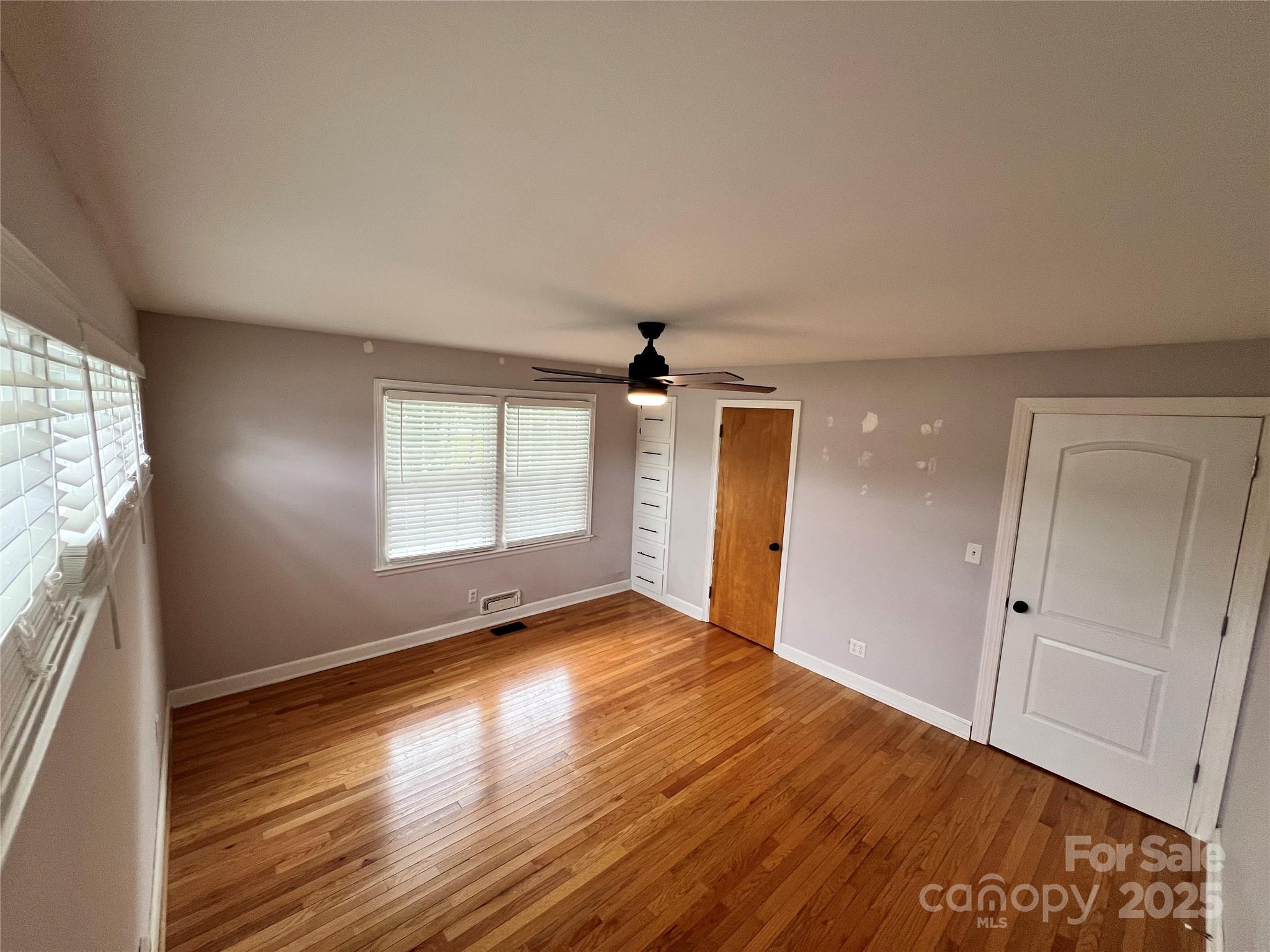 800 Charles Road Shelby, NC 28152 - Photo 17 of 21 an empty room with wooden floor and windows