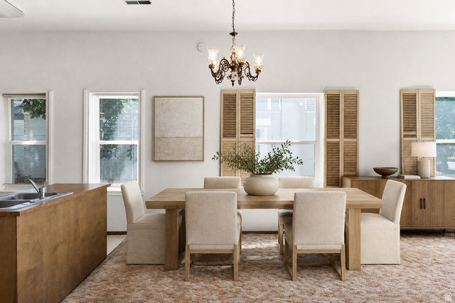 299 West Center Street, Unit 2 Logan, UT 84321 - Photo 15 of 46 Spacious dining area featuring a chandelier, light wood-finish dining table, and upholstered chairs