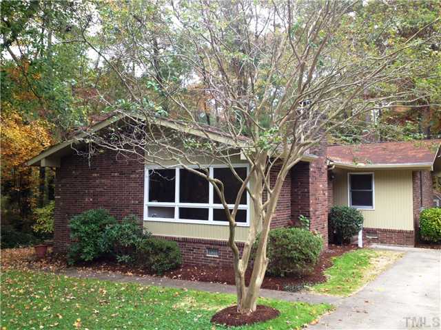 1901 Fountain Ridge Road Chapel Hill, NC 27517 - Photo 2 of 7 a front view of a house with a yard and garage