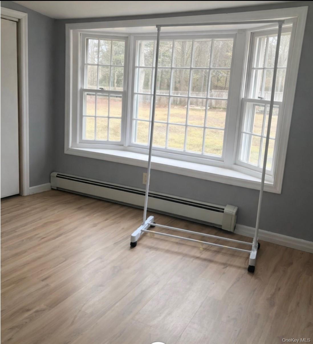 261 Titusville Road Poughkeepsie, NY 12603 - Photo 17 of 18 a living room with hardwood floor and windows