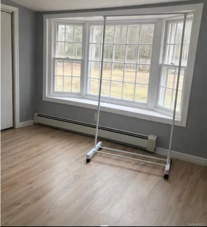 a living room with hardwood floor and windows