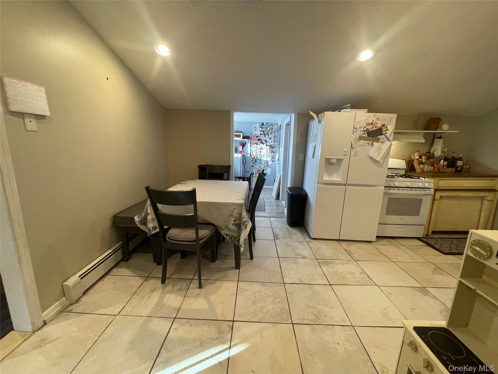 261 Titusville Road Poughkeepsie, NY 12603 - Photo 10 of 18 a kitchen with a dining table chairs and a refrigerator