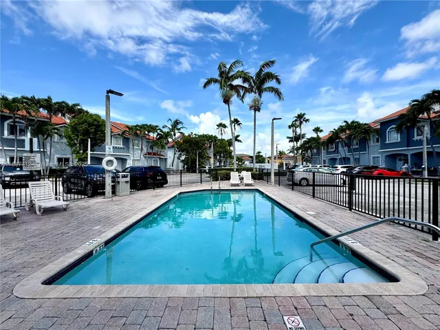 a view of a swimming pool with outdoor seating