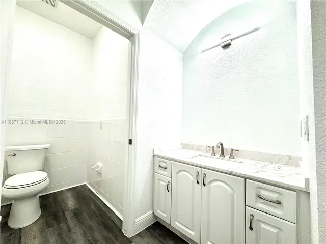 a couple of palm trees sitting in front of a house