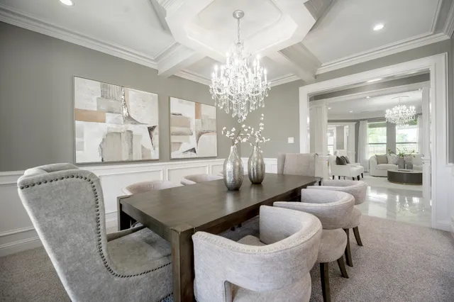 a view of a dining room with furniture and chandelier