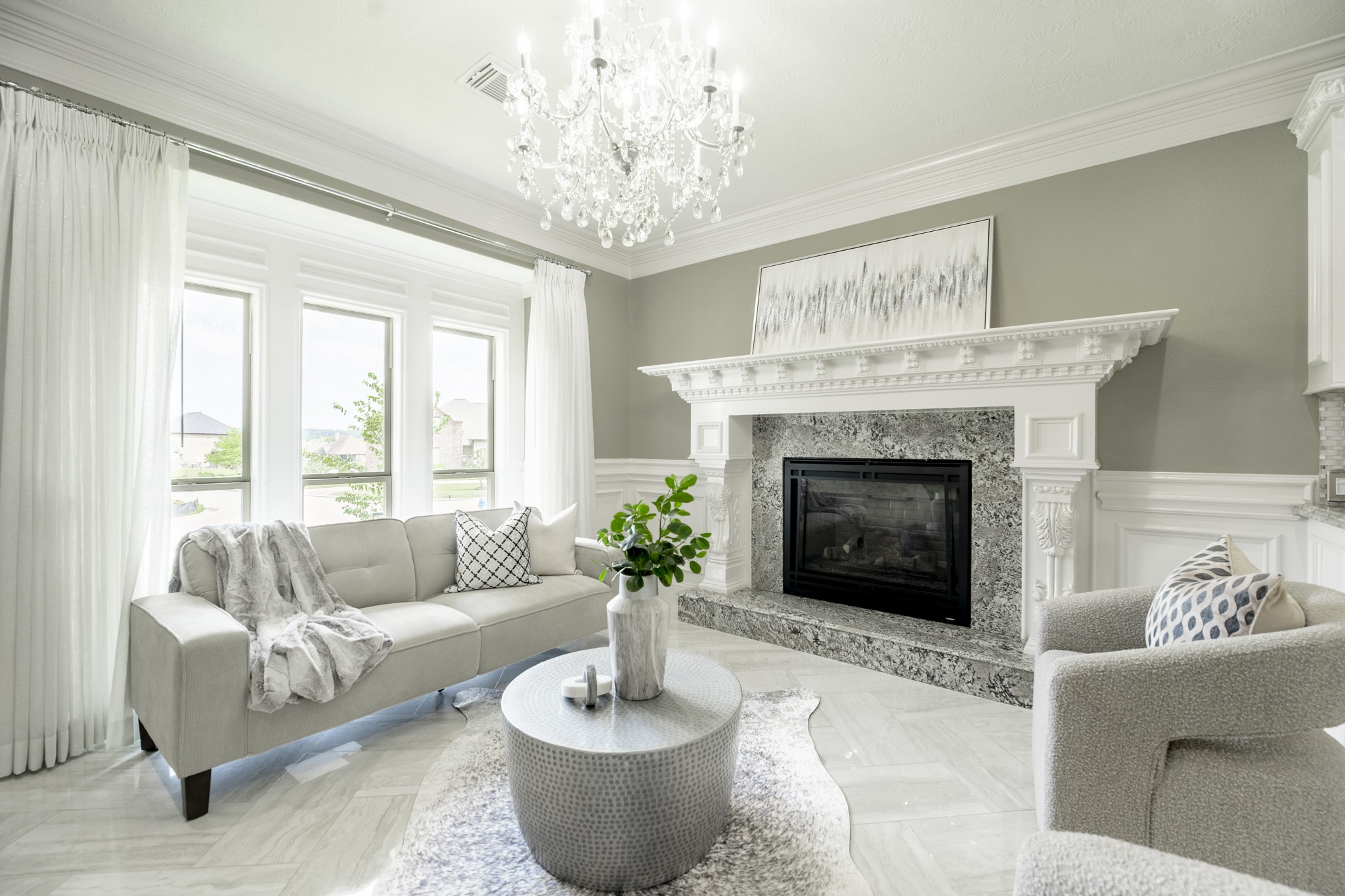 10887 Decatur Street Willis, TX 77318 - Photo 20 of 50 a living room with furniture a fireplace and a chandelier