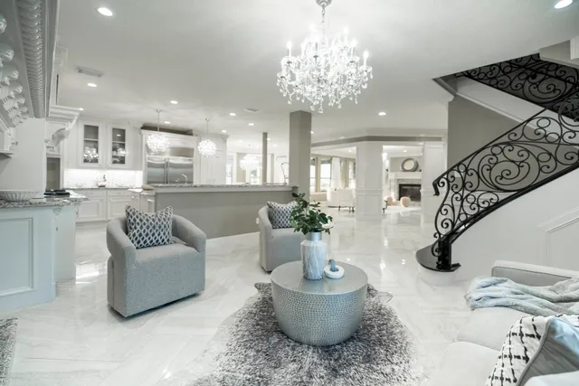 a living room with furniture and a chandelier