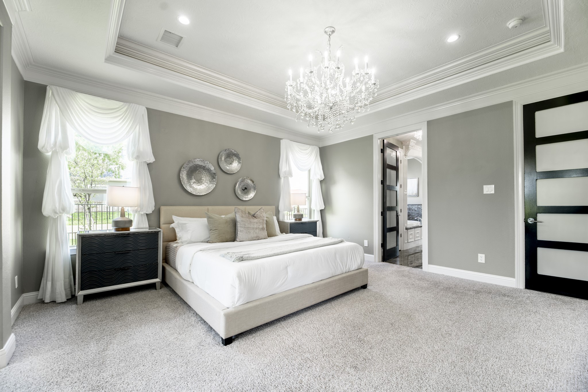 10887 Decatur Street Willis, TX 77318 - Photo 24 of 50 a bedroom with a bed and a chandelier