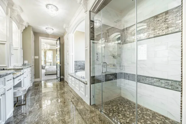 a bathroom with a glass shower door and a bathtub