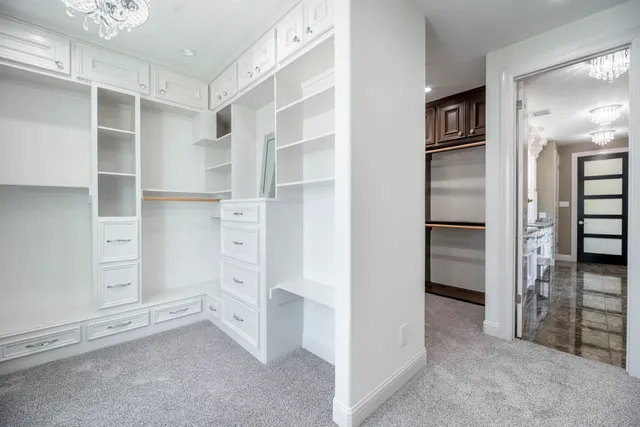 a view of walk in closet with cabinet
