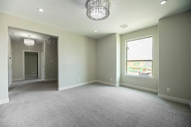 an empty room with a window and a mirror