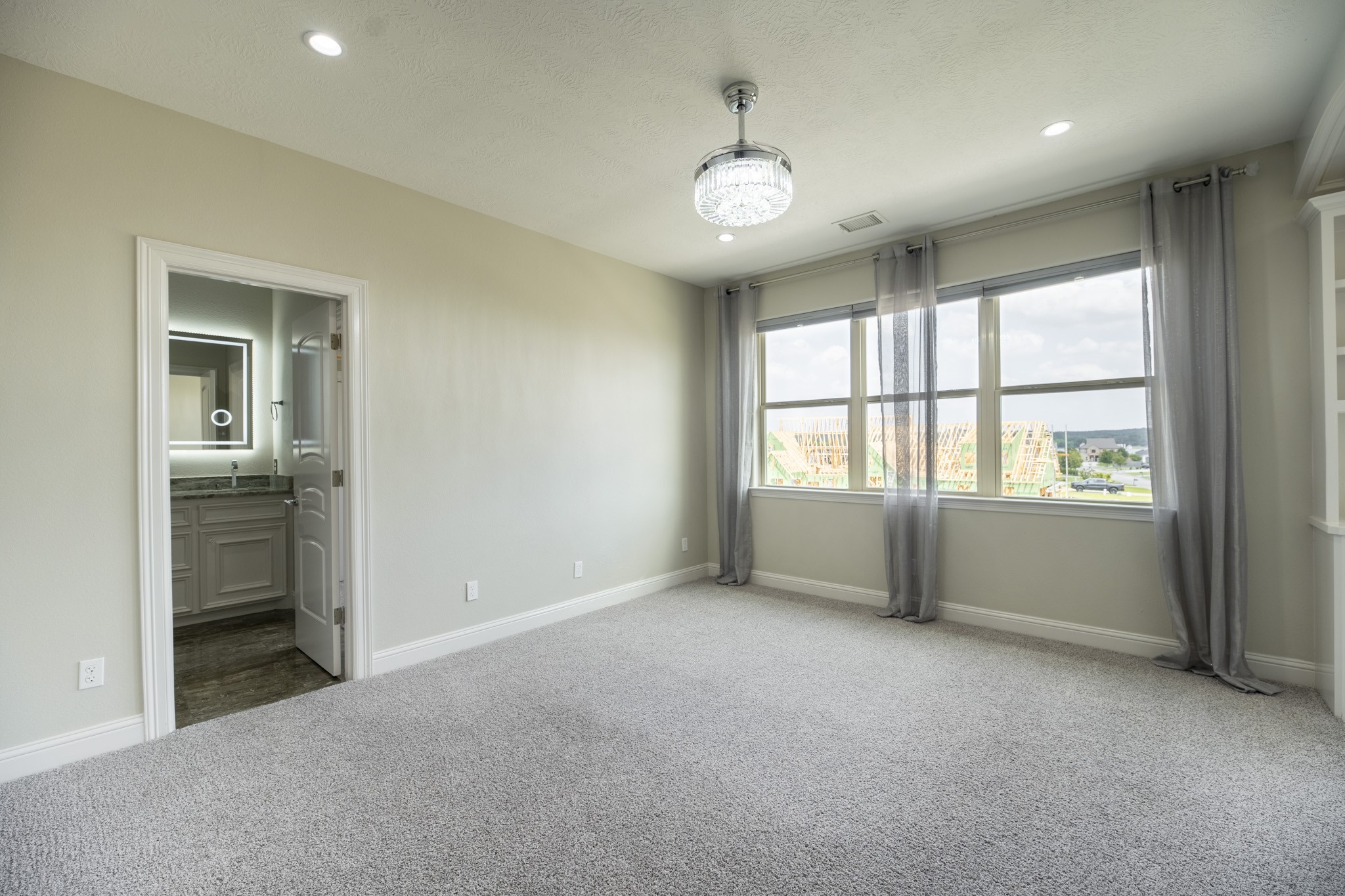 10887 Decatur Street Willis, TX 77318 - Photo 36 of 50 an empty room with windows and chandelier fan