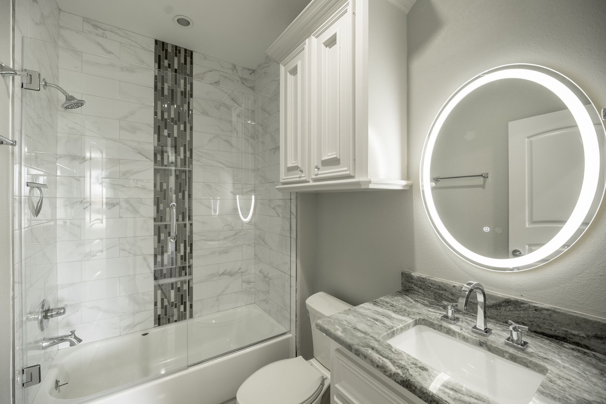 10887 Decatur Street Willis, TX 77318 - Photo 44 of 50 a bathroom with a granite countertop toilet a sink and a mirror