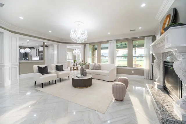 a living room with fireplace furniture and a large window