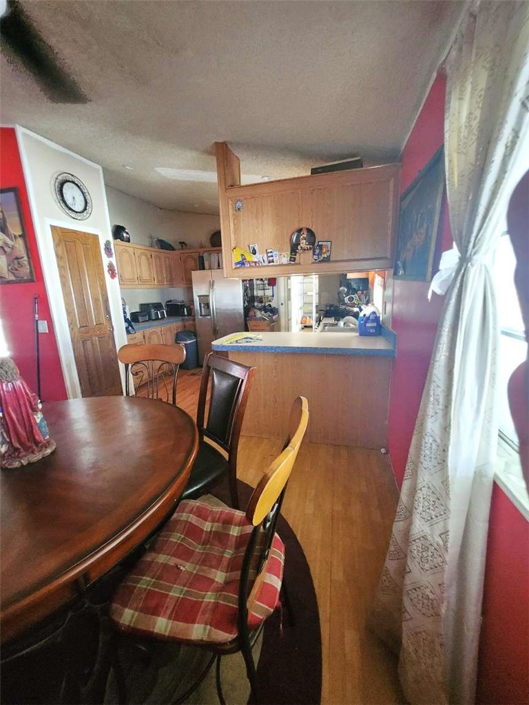 1855 East Riverside Drive, Unit 388 Ontario, CA 91761 - Photo 8 of 17 a dining room with furniture and window