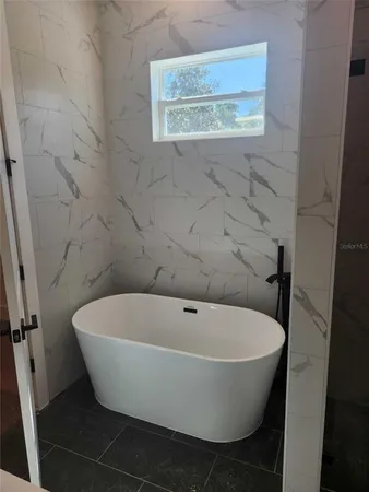 a white bath tub sitting in a bathroom