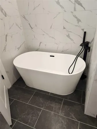 a white bath tub sitting in a bathroom