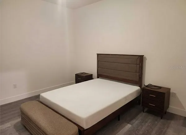 a bedroom with a bed and a dresser