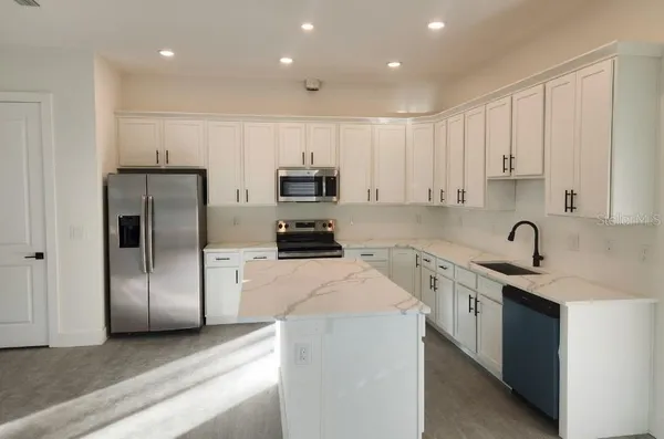 a kitchen with cabinets and stainless steel appliances