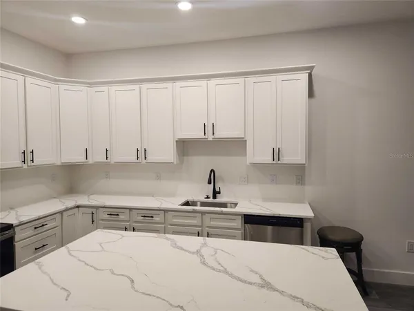a kitchen with a white cabinets and sink