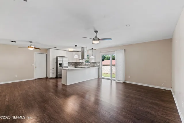 a view of a kitchen with a sink cabinets and wooden floor
