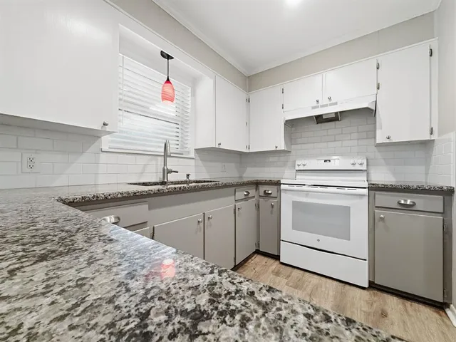 a kitchen with a sink cabinets and window