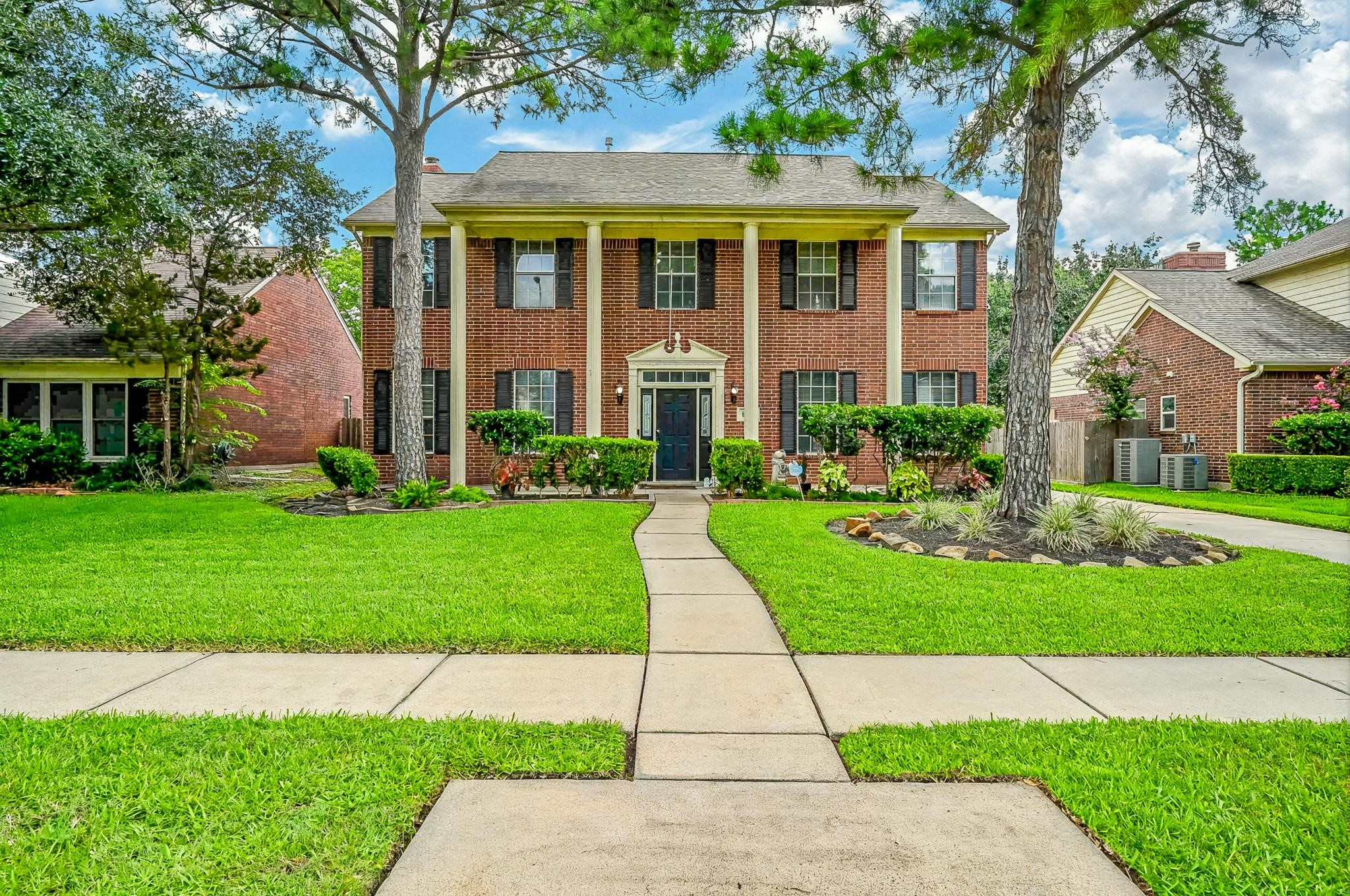 17518 Rustling Aspen Lane Houston, TX 77095 - Photo 2 of 39 a front view of a house with a yard