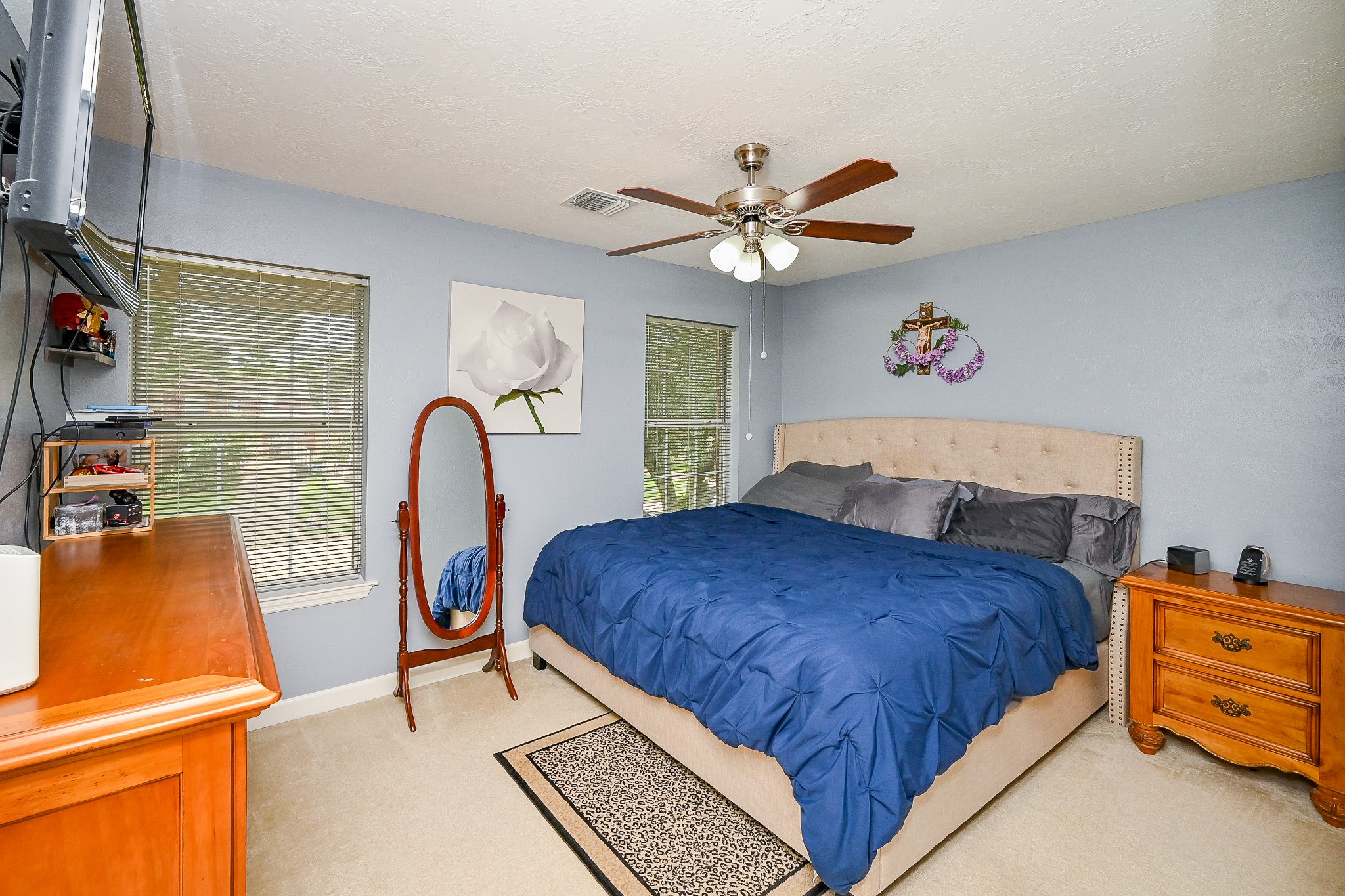 17518 Rustling Aspen Lane Houston, TX 77095 - Photo 22 of 39 a bedroom with a bed and a flat screen tv