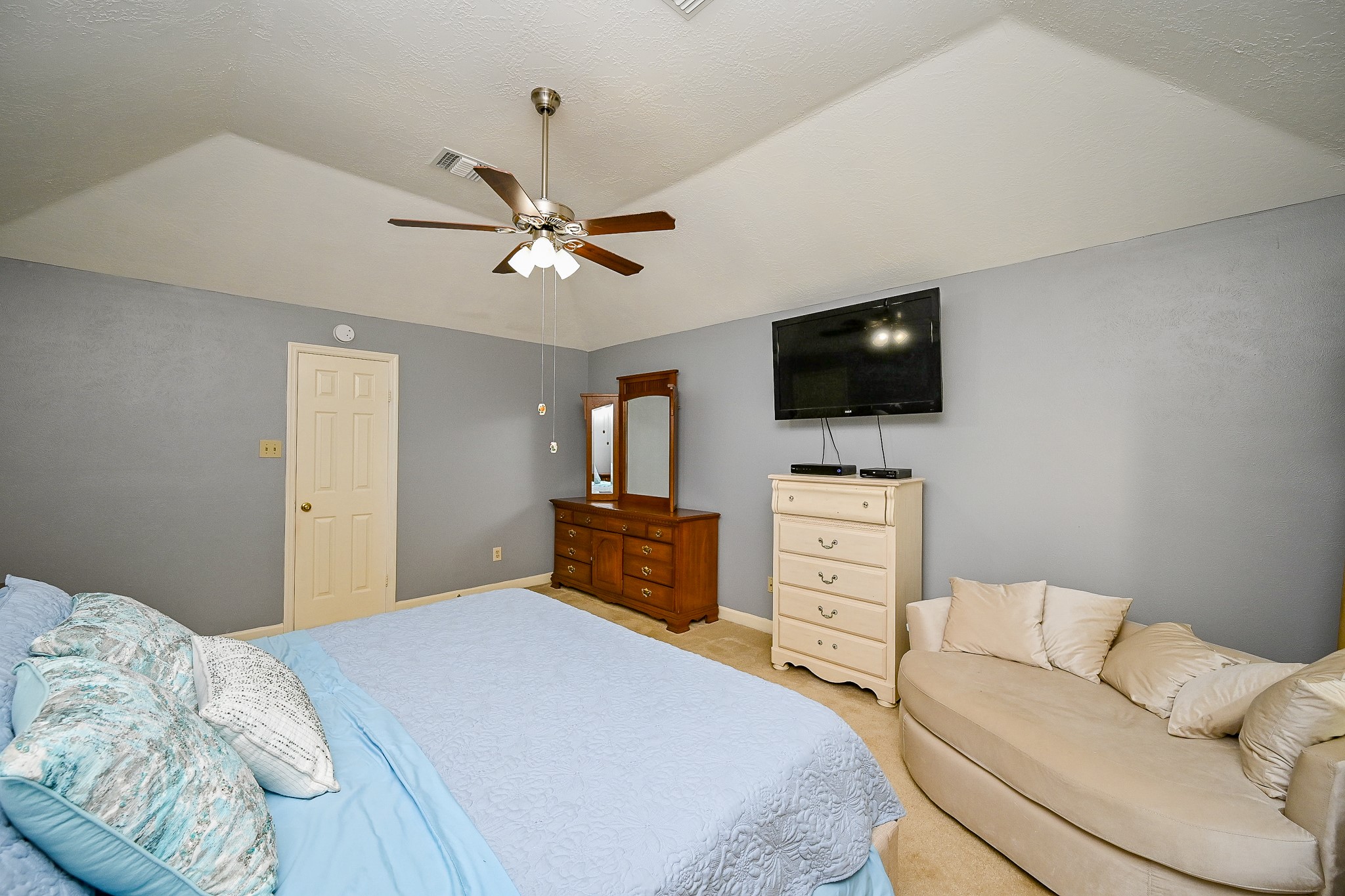17518 Rustling Aspen Lane Houston, TX 77095 - Photo 29 of 39 a bedroom with a bed and a flat screen tv