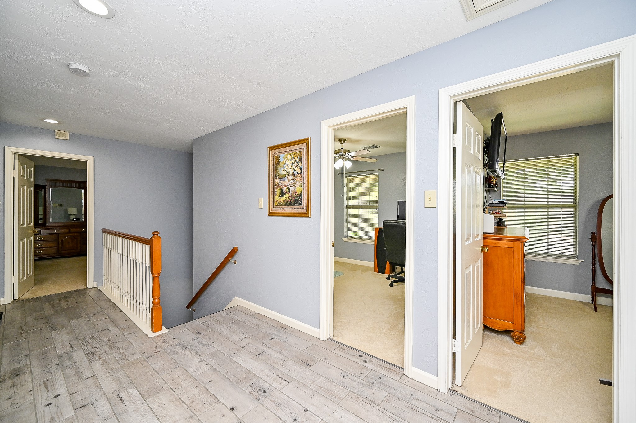 17518 Rustling Aspen Lane Houston, TX 77095 - Photo 30 of 39 a view of a hallway with wooden floor and staircase