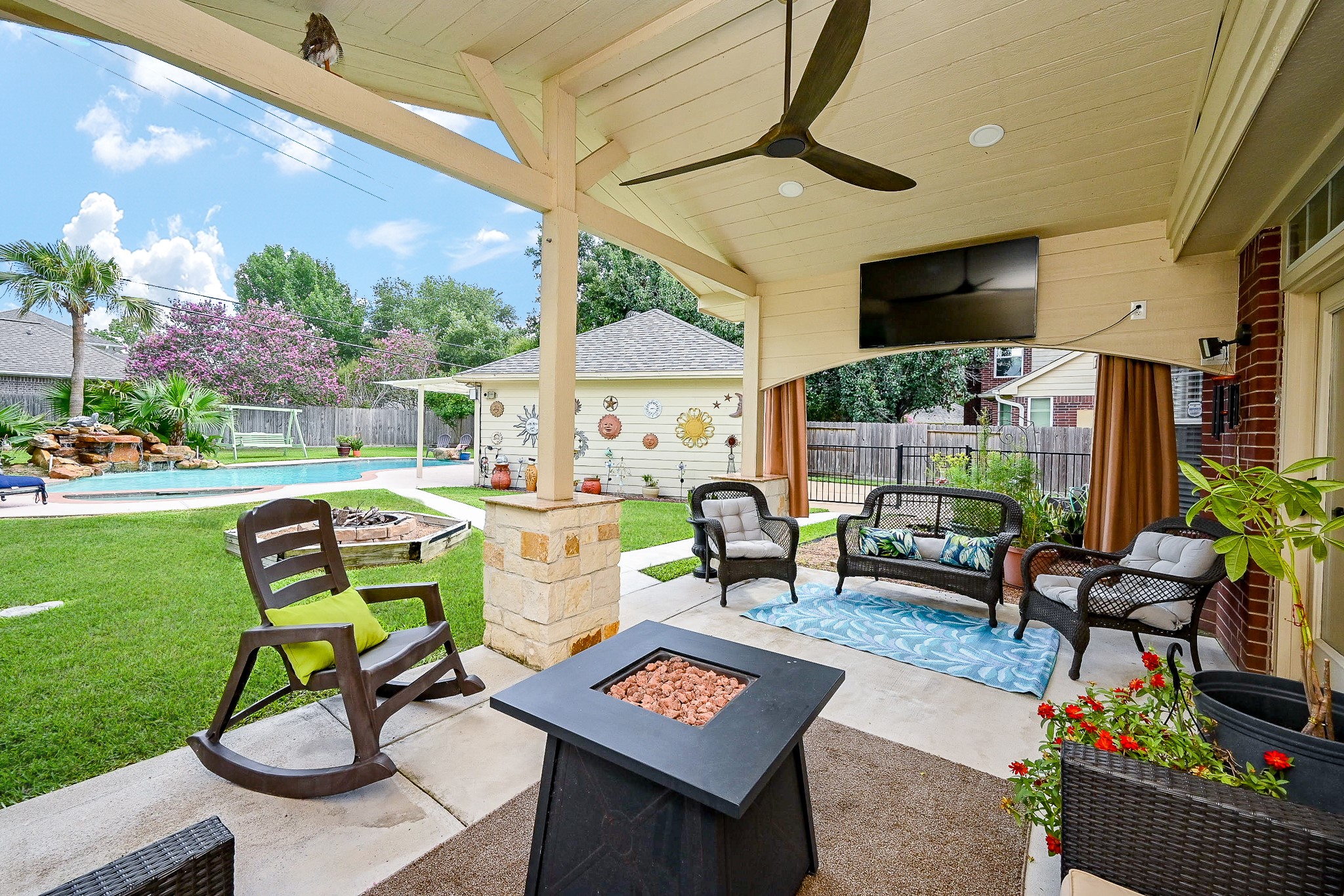 17518 Rustling Aspen Lane Houston, TX 77095 - Photo 33 of 39 a view of a patio with table and chairs potted plants and a palm tree