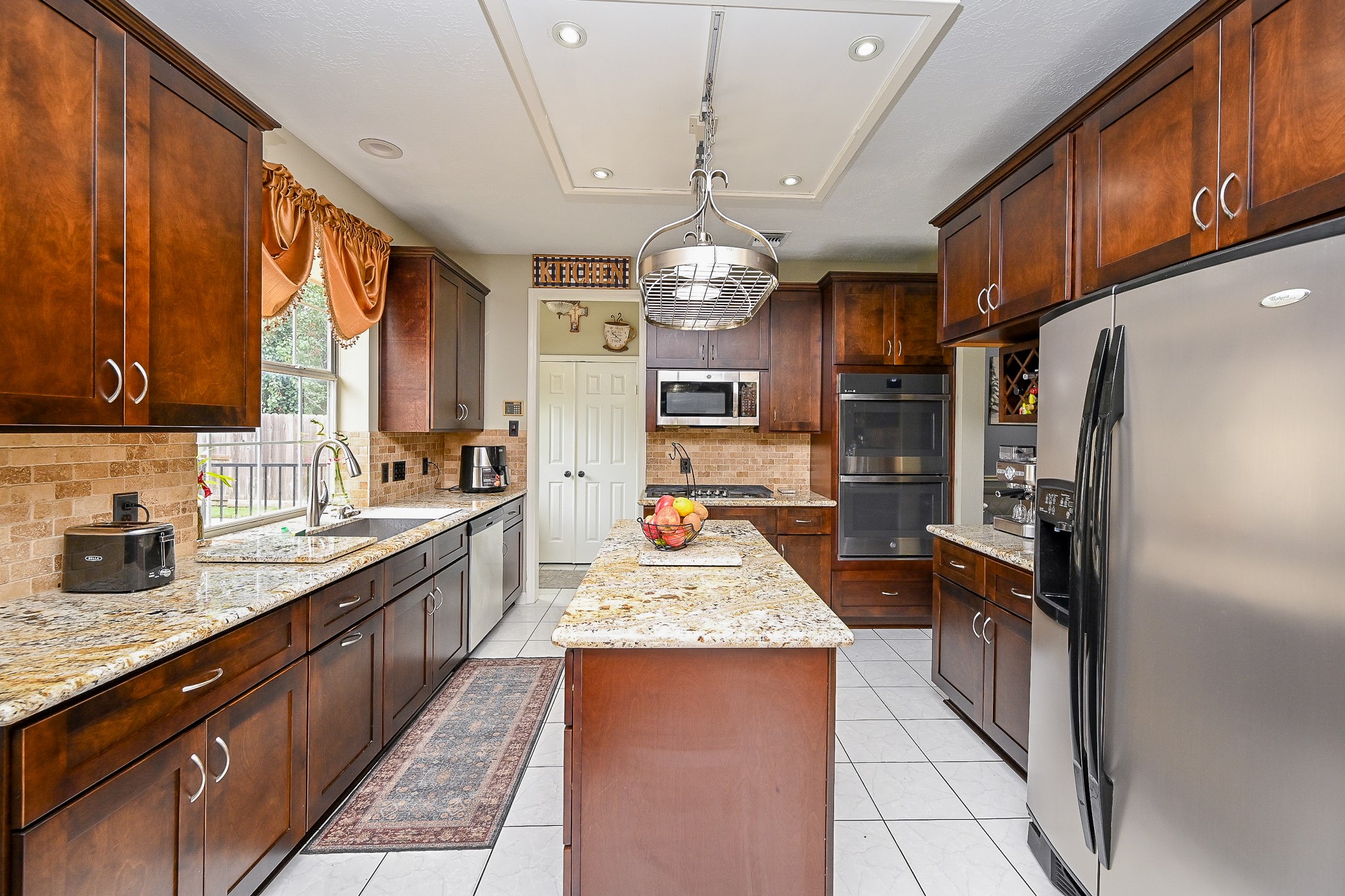 17518 Rustling Aspen Lane Houston, TX 77095 - Photo 10 of 39 a kitchen with granite countertop stainless steel appliances a counter space and a window