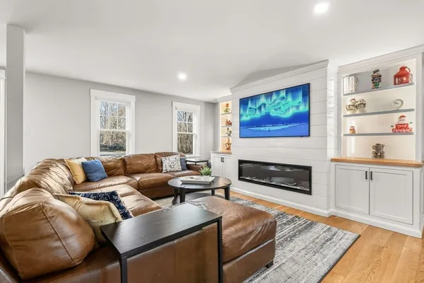 a living room with furniture and a fireplace