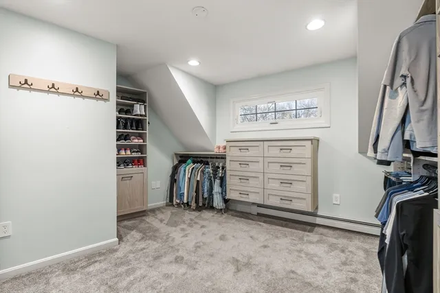 a view of walk in closet with clothes