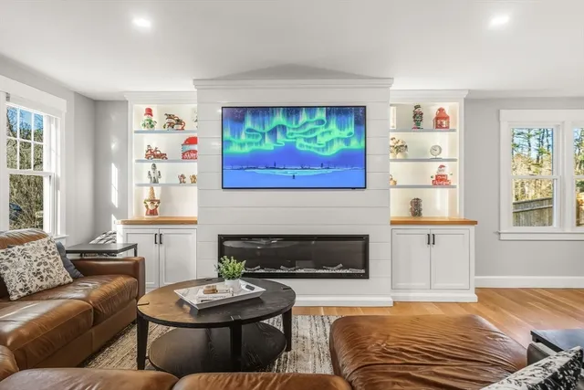 a living room with furniture and a fireplace
