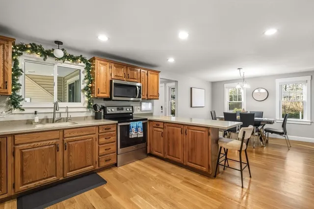 a large kitchen with stainless steel appliances granite countertop a large center island and a wooden cabinets