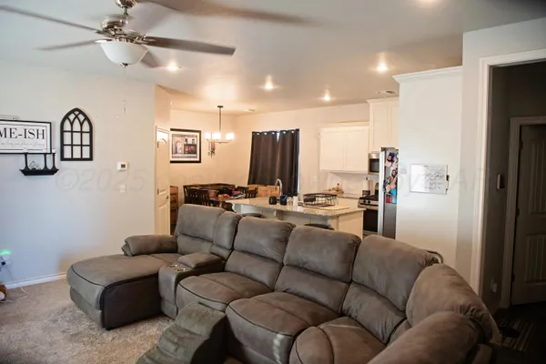 a kitchen with stainless steel appliances granite countertop a sink refrigerator and microwave