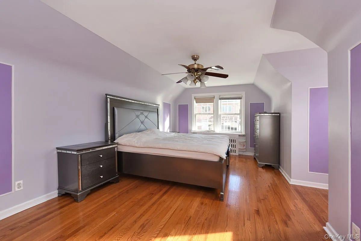 108-30 67th Avenue Queens, NY 11375 - Photo 11 of 29 a bedroom with a bed and a chandelier