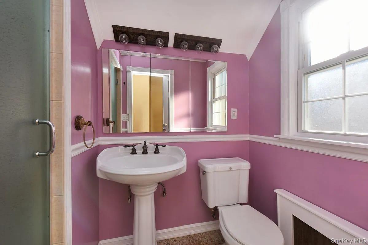 108-30 67th Avenue Queens, NY 11375 - Photo 14 of 29 a bathroom with a sink and a mirror