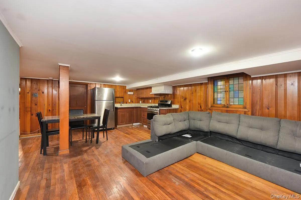 108-30 67th Avenue Queens, NY 11375 - Photo 16 of 29 a living room with furniture a wooden floor and next to a window