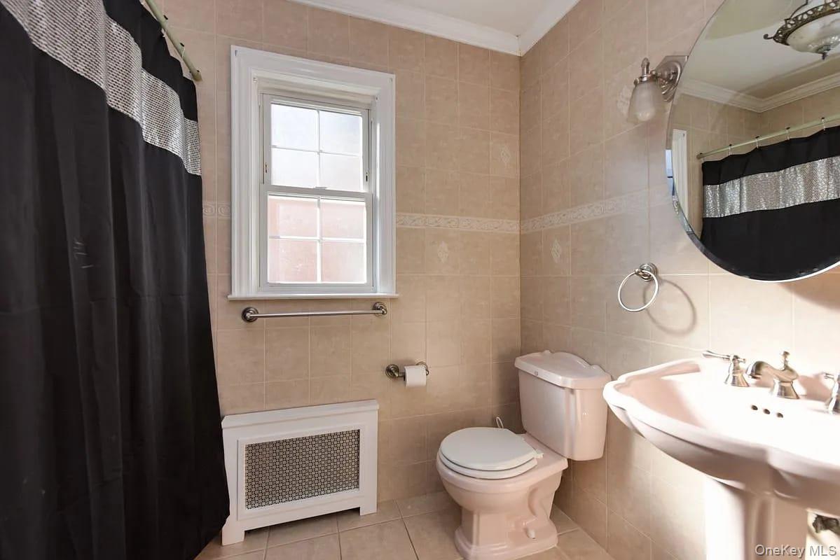 108-30 67th Avenue Queens, NY 11375 - Photo 19 of 29 a bathroom with a sink toilet and shower