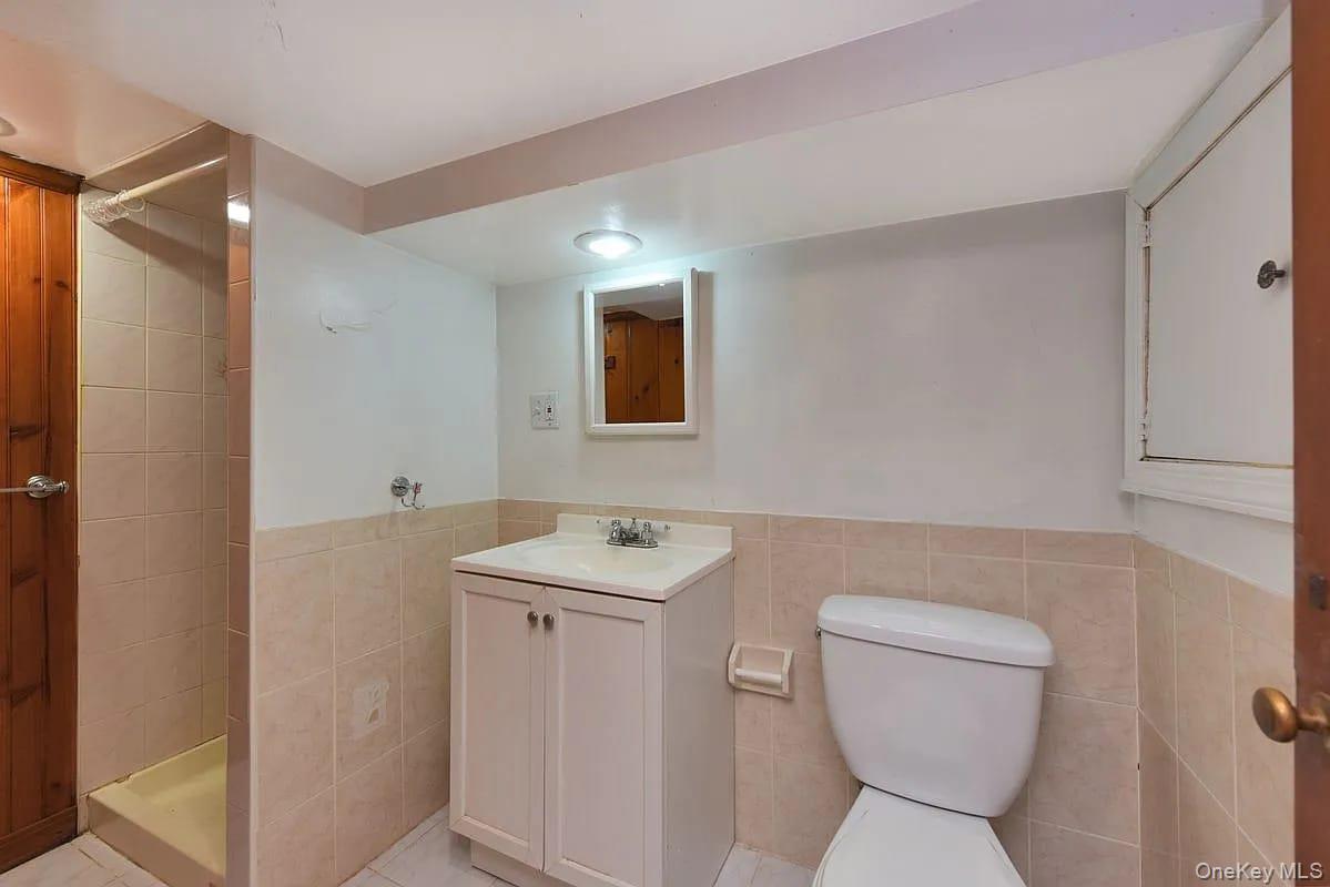 108-30 67th Avenue Queens, NY 11375 - Photo 20 of 29 a bathroom with a toilet sink and mirror