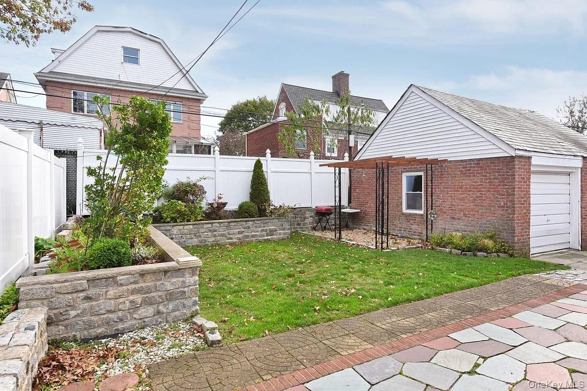 108-30 67th Avenue Queens, NY 11375 - Photo 26 of 29 a front view of a house with a yard